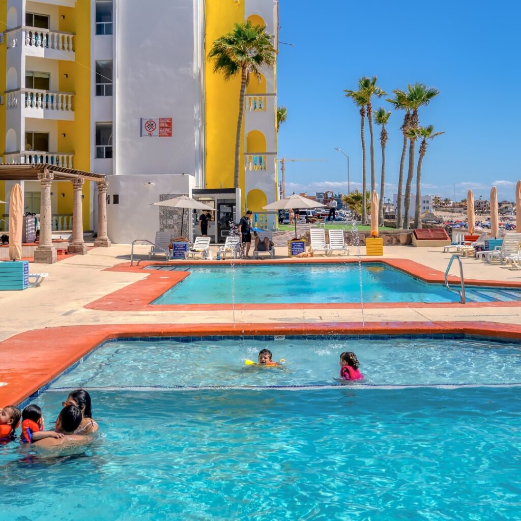 Guests enjoying the heated pool with ocean views at Playa Bonita Resort in Rocky Point