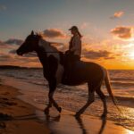 Horseback riding on the beach at sunset in Rocky Point