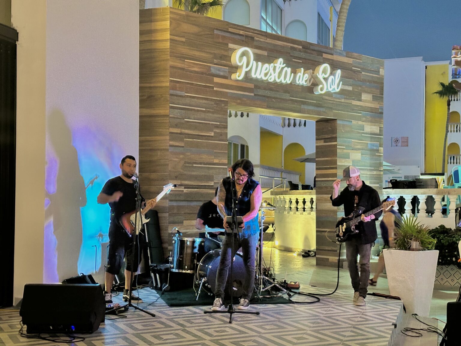 Live band performing at Puesta del Sol restaurant at Playa Bonita Resort, with instruments and stage lighting during an evening show.