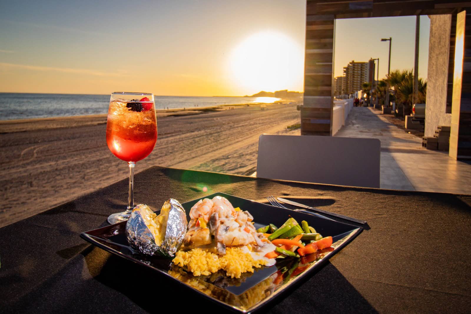 Oceanfront dinner during golden hour at Puesta del Sol Restaurant